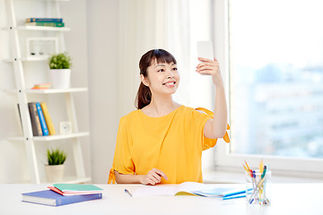 Image showing asian woman student taking selfie with smartphone