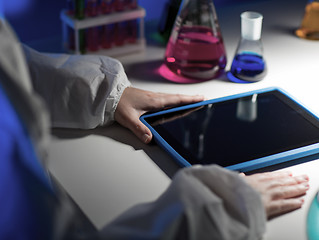 Image showing close up of scientist with tablet pc in laboratory