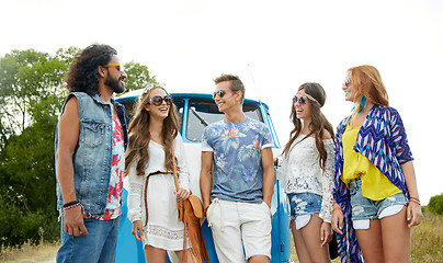 Image showing smiling young hippie friends over minivan car