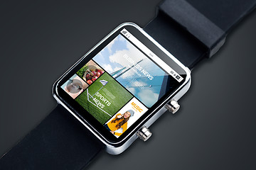 Image showing close up of smart watch with news pages on screen