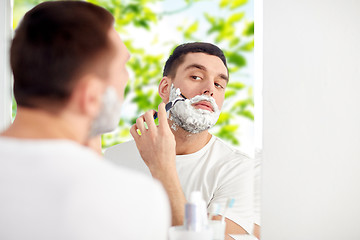 Image showing man shaving beard with razor blade at bathroom