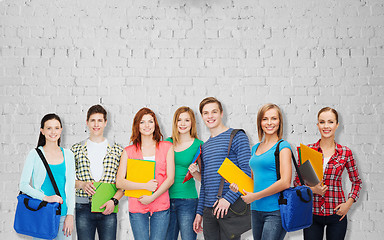 Image showing group of teenage students with folders and bags