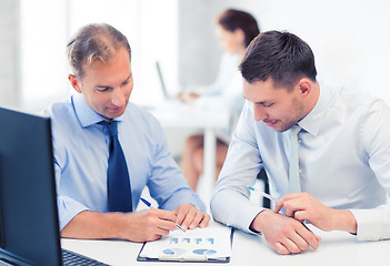 Image showing businessmen with notebook on meeting