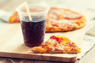Image showing close up of pizza with coca cola on table
