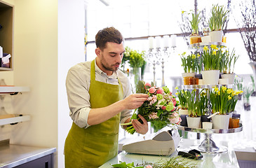 Image showing florist man making bunch at flower shop