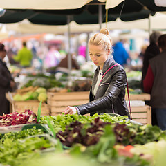 Image showing Woman buying vegetable at local food market. 