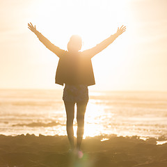 Image showing Free woman enjoying freedom on beach at sunset.