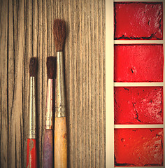 Image showing Three brushes for painting and a paint-box