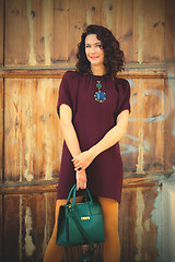 Image showing beautiful middle-aged woman in a burgundy dress 