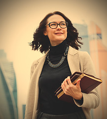 Image showing smiling middle-aged woman with books