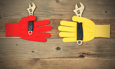 Image showing protective gloves with pipe wrench