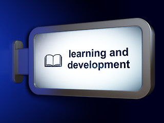 Image showing Studying concept: Learning And Development and Book on billboard background