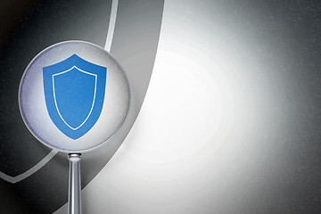 Image showing Privacy concept:  Shield with optical glass on digital background