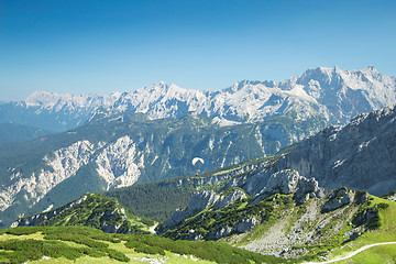 Image showing Alps mountains aerial view with paraglider over Alpine landscape