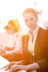 Image showing business woman at  office people group on meeting  in background