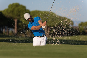 Image showing pro golfer hitting a sand bunker shot