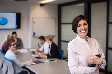 Image showing hispanic businesswoman with tablet at meeting room