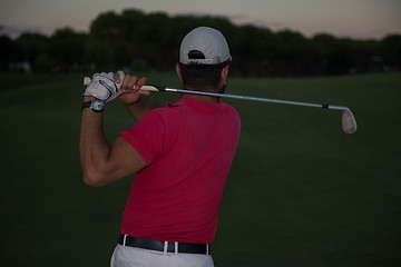 Image showing golfer hitting a sand bunker shot on sunset