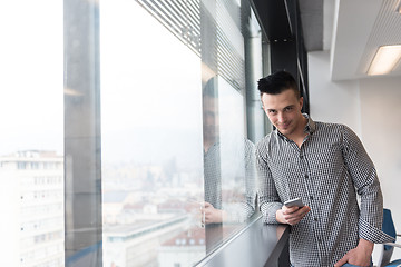 Image showing young business man using smart phone at office