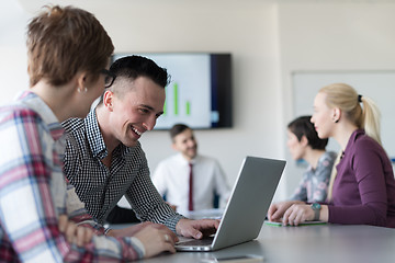 Image showing young business couple working on laptop, businesspeople group on