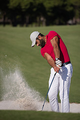 Image showing golfer hitting a sand bunker shot