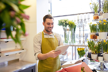 Image showing man with tablet pc computer at flower shop