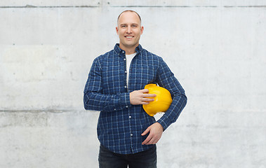 Image showing smiling man with helmet over concrete wall