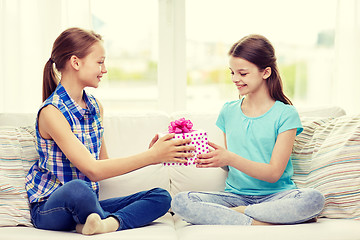 Image showing happy little girls with birthday present at home