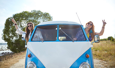 Image showing smiling young hippie women driving minivan car