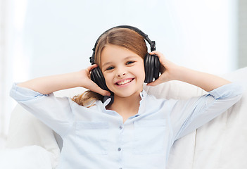 Image showing smiling girl with headphones listening to music