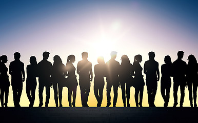 Image showing silhouettes of students on stairs over sun