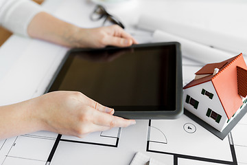 Image showing close up of hand with blueprint and tablet pc