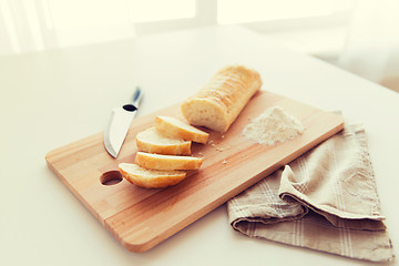 Image showing close up of white bread or baguette and knife