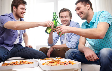 Image showing close up of friends with beer and pizza at home