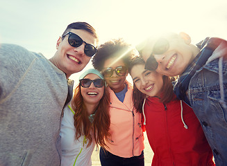 Image showing smiling friends taking selfie