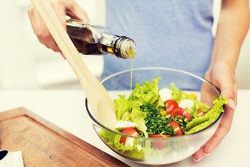 Image showing close up of woman cooking vegetable salad at home