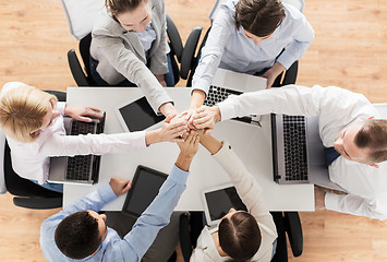 Image showing close up of business team with hands on top