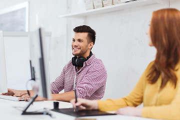 Image showing creative team with headphones and computer