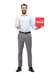 Image showing smiling man with red shopping bag