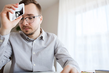 Image showing businessman with smarphone at home office