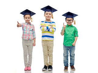 Image showing happy children in bachelor hats and eyeglasses