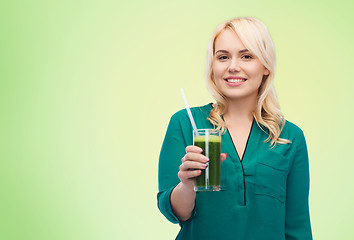 Image showing smiling woman drinking vegetable juice or smoothie