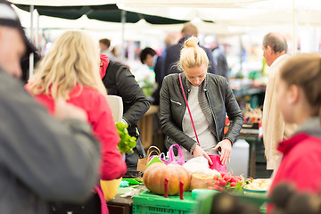 Image showing Woman buying vegetable at local food market. 