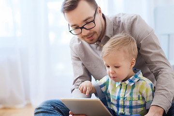 Image showing father and son with tablet pc playing at home