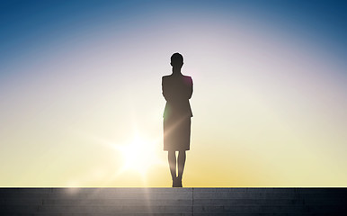 Image showing silhouette of business woman with over sun light