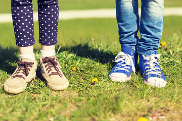 Image showing close up of kids legs in shoes on grass outdoors