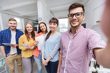 Image showing creative business team taking selfie at office