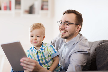 Image showing father and son with tablet pc playing at home