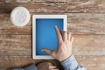 Image showing close up of male hands with tablet pc and coffee