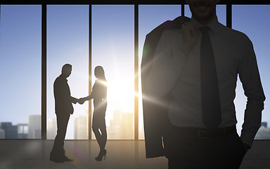 Image showing business partners silhouettes shaking hands